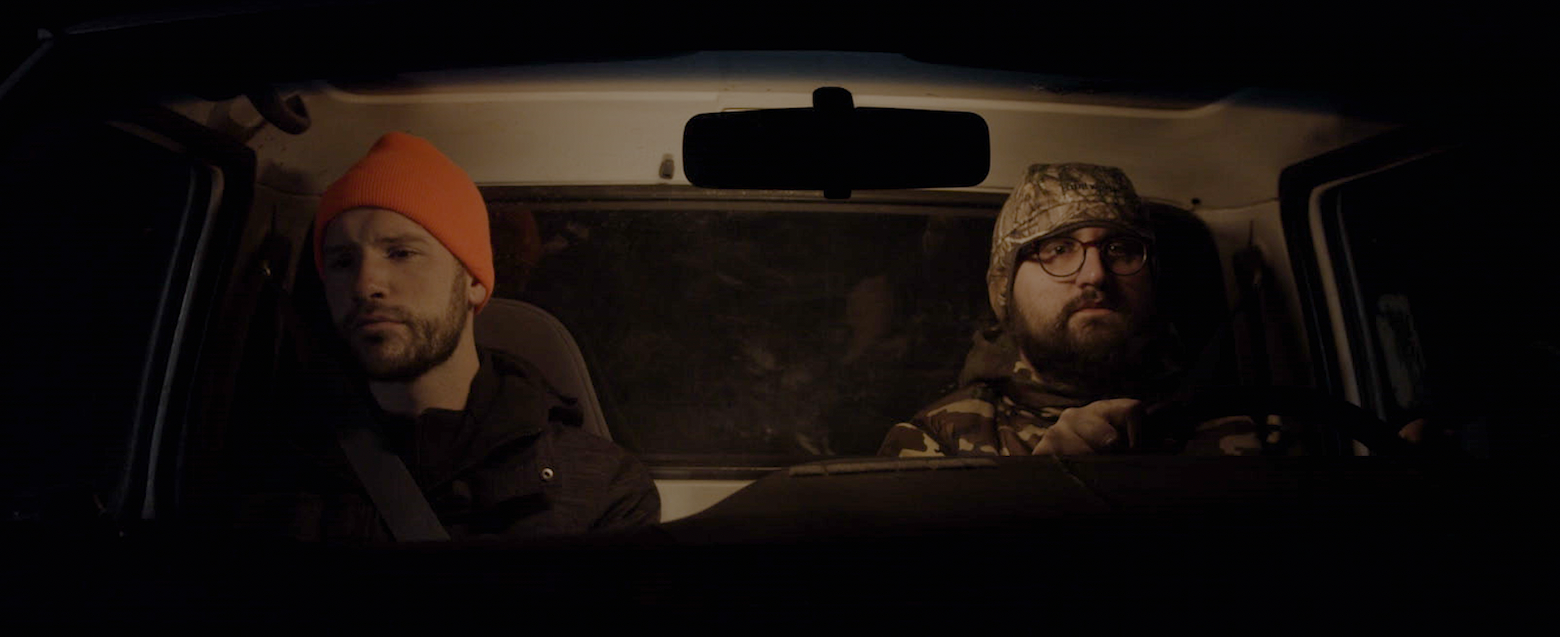 Two guys in a truck at night