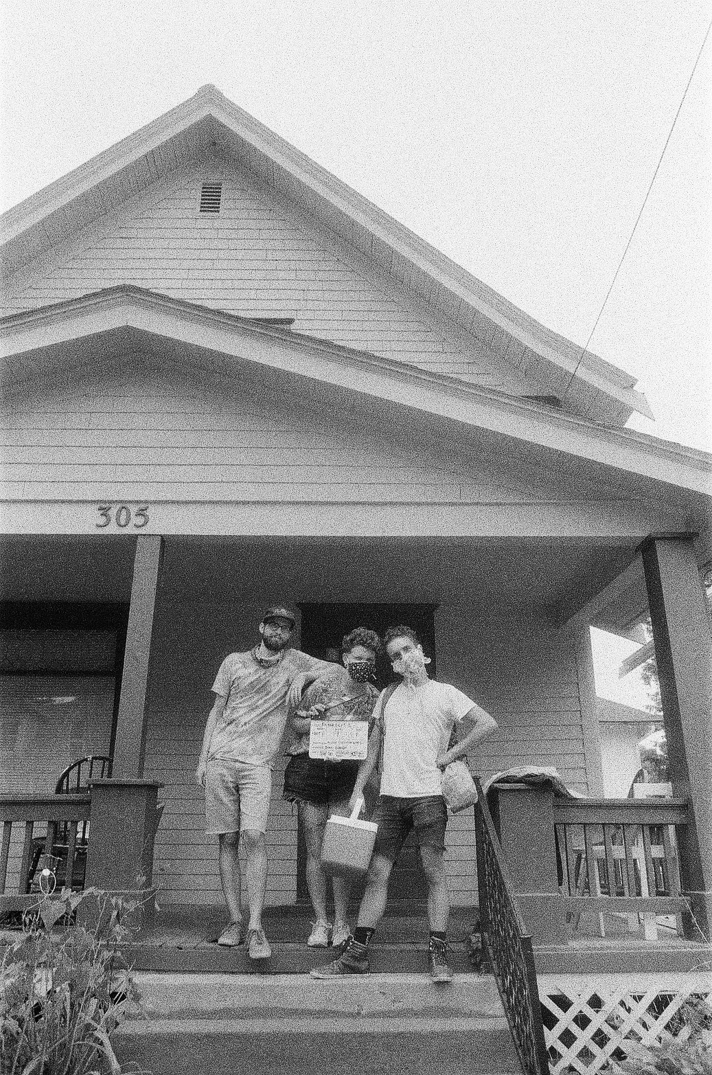 Three people standing on a porch