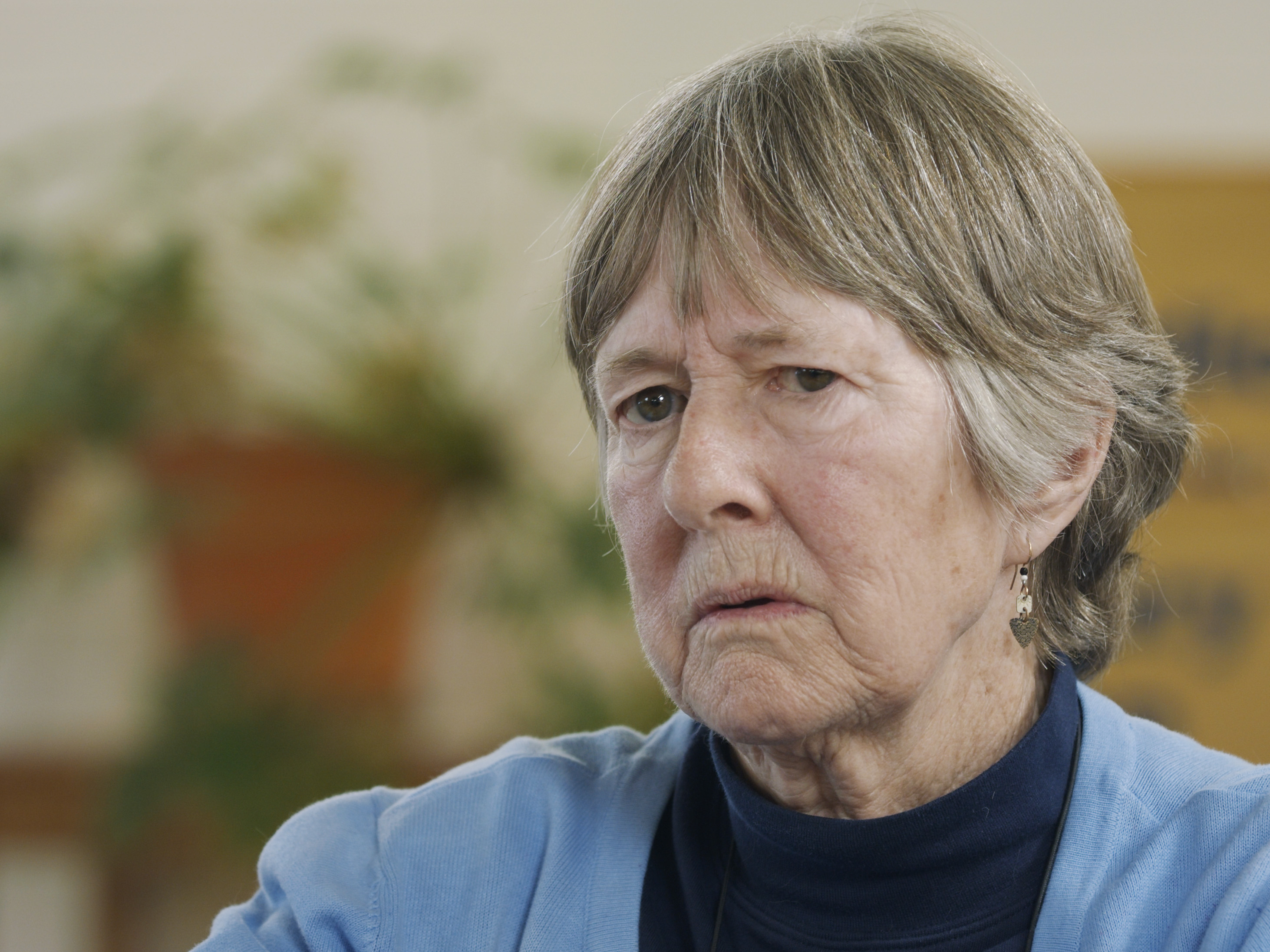 Woman in library looking perplexed.