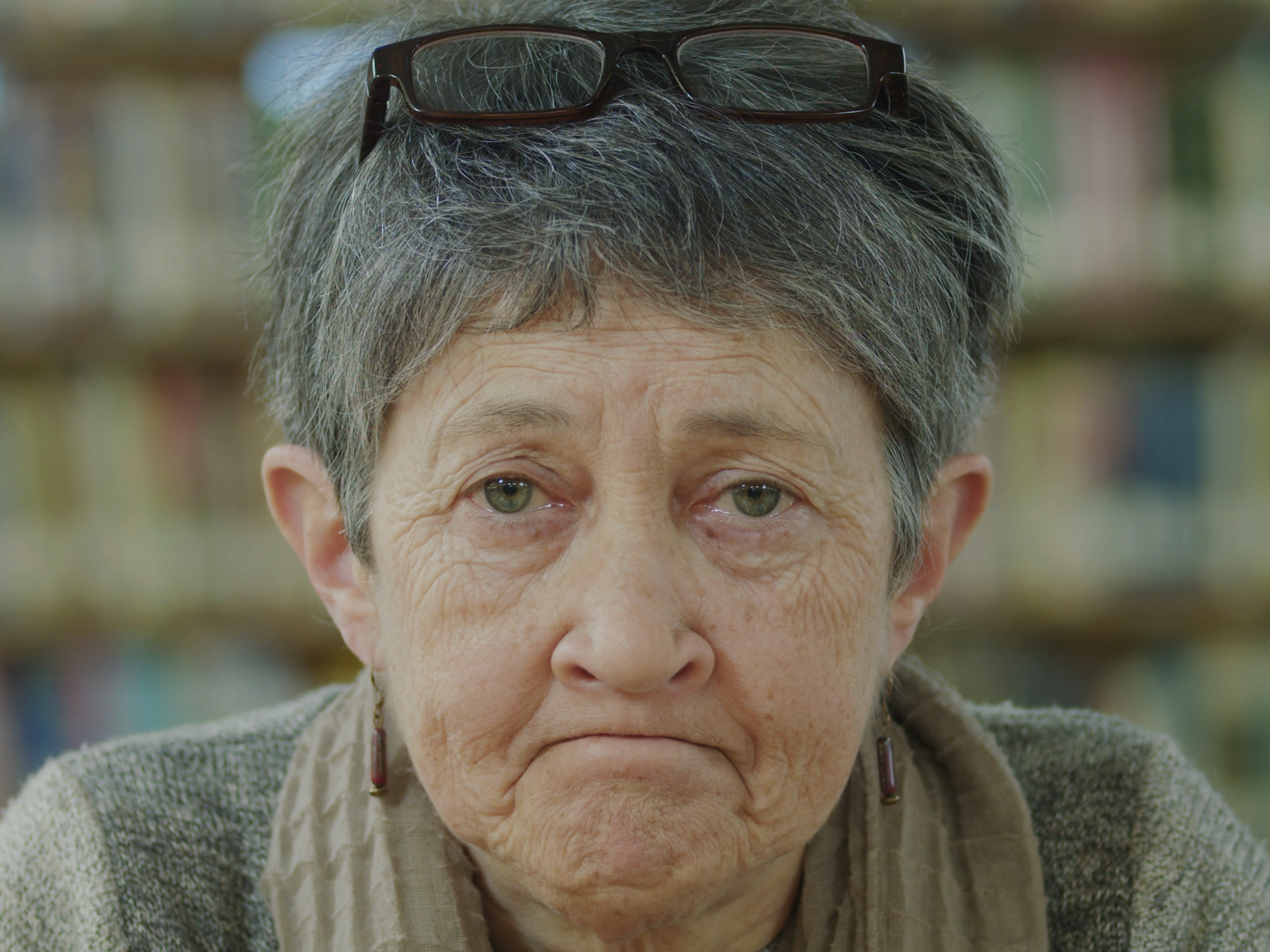 Woman in library frowning.
